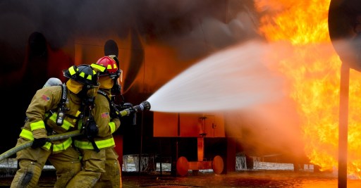 Firefighters putting out a fire with a hose